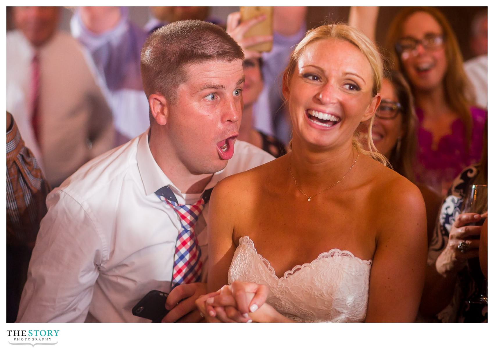wedding guest having fun with with bride at wedding reception