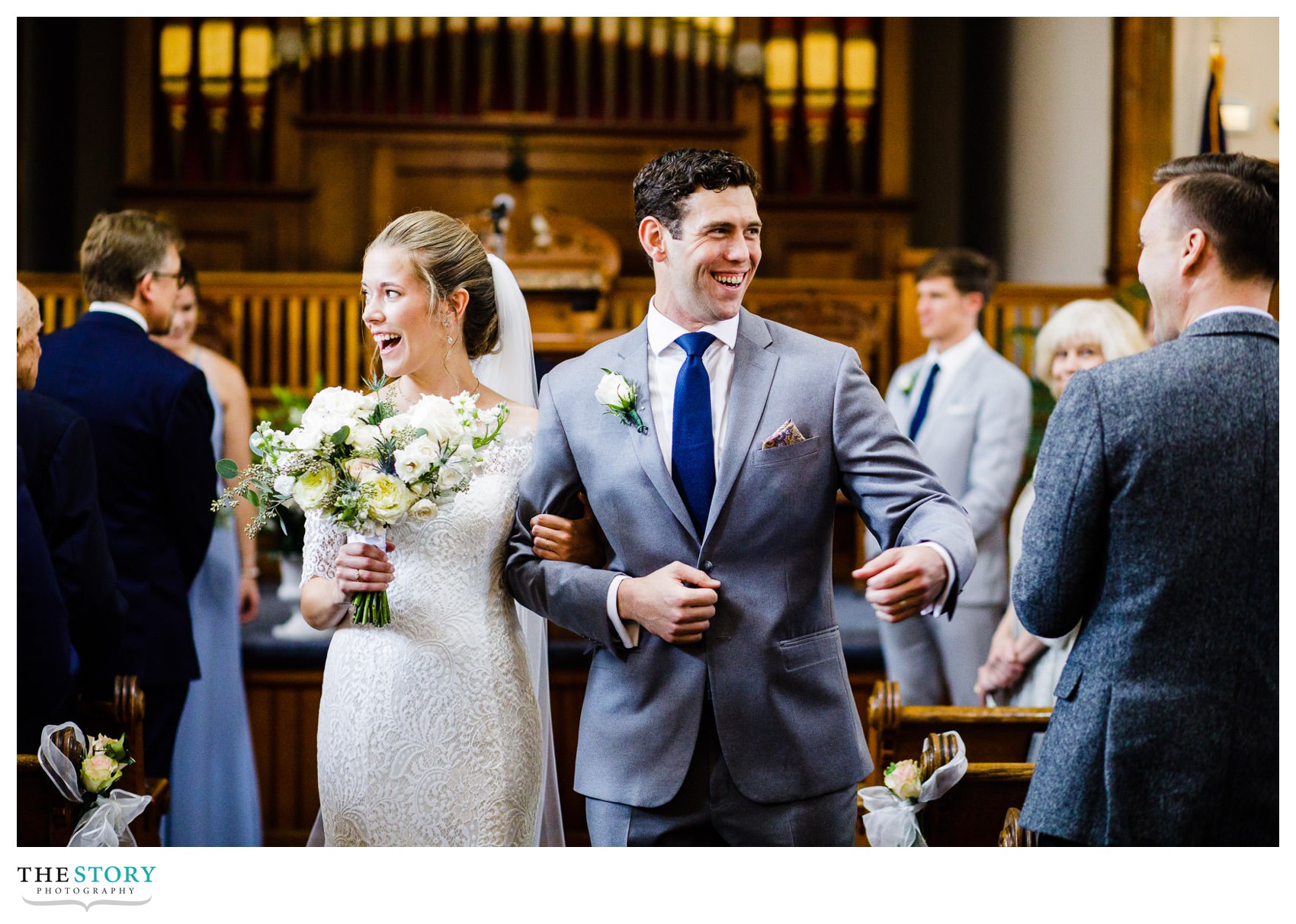 bride and groom happily walk down the aisle for the first time