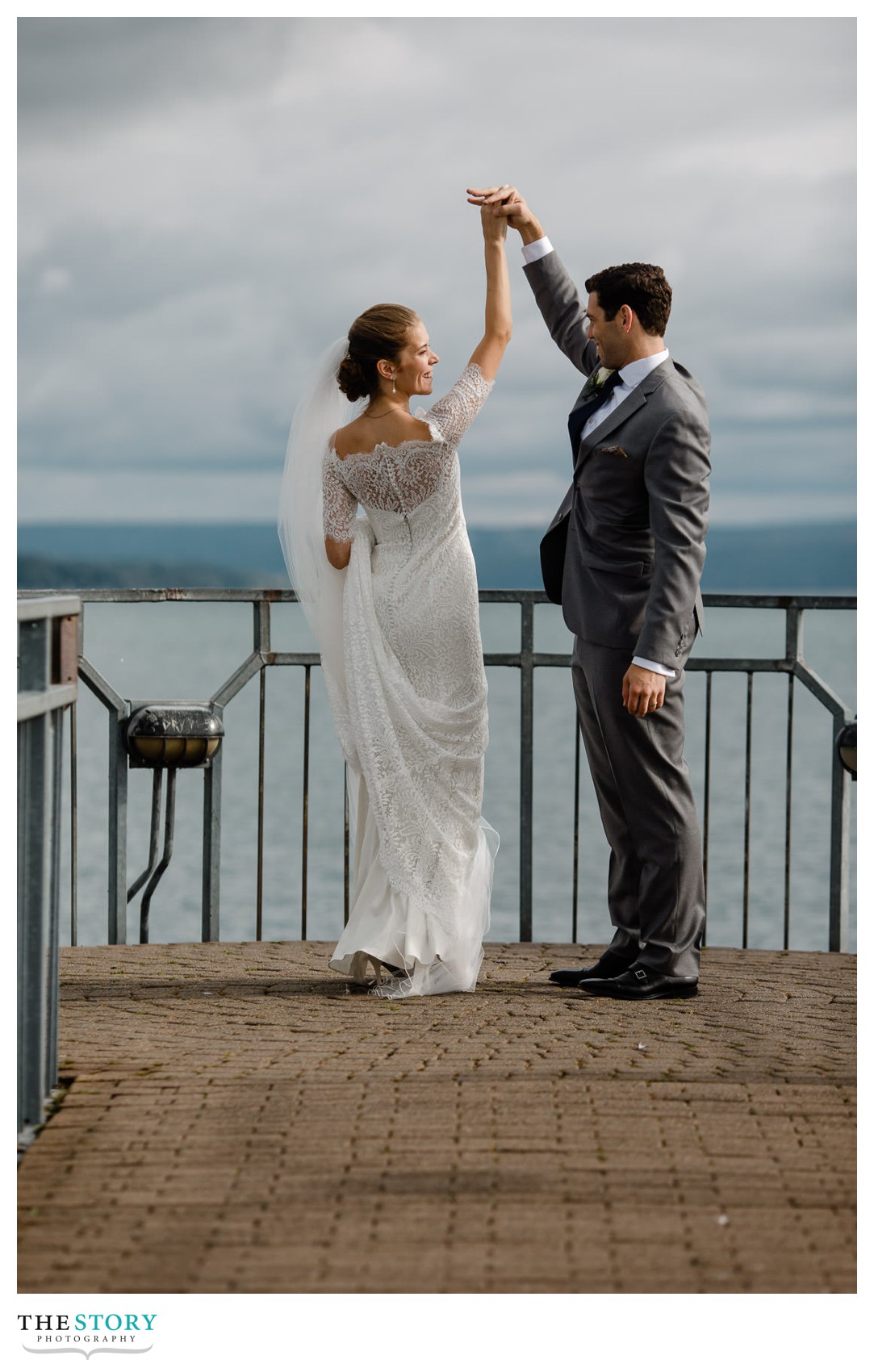 bride and groom dance on wedding day on Skaneateles Pier