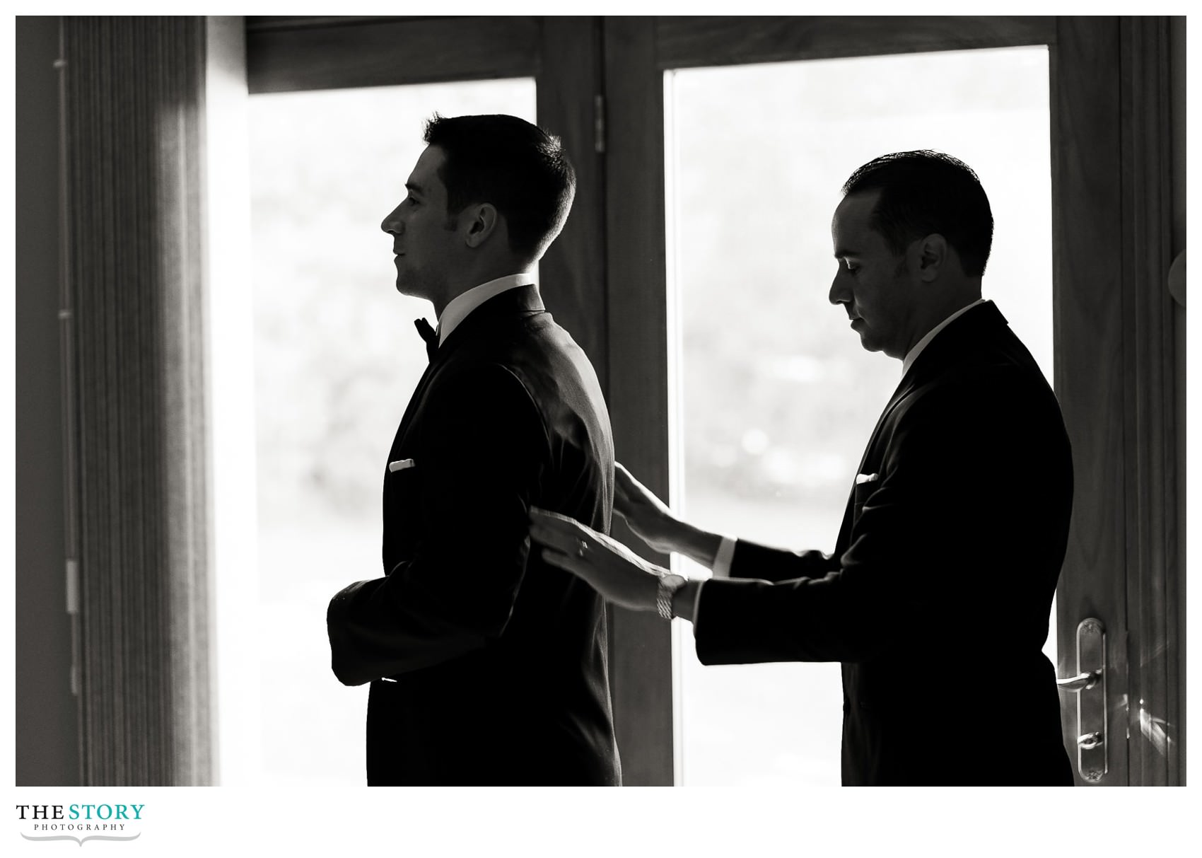 groom getting ready for the wedding day with the best man