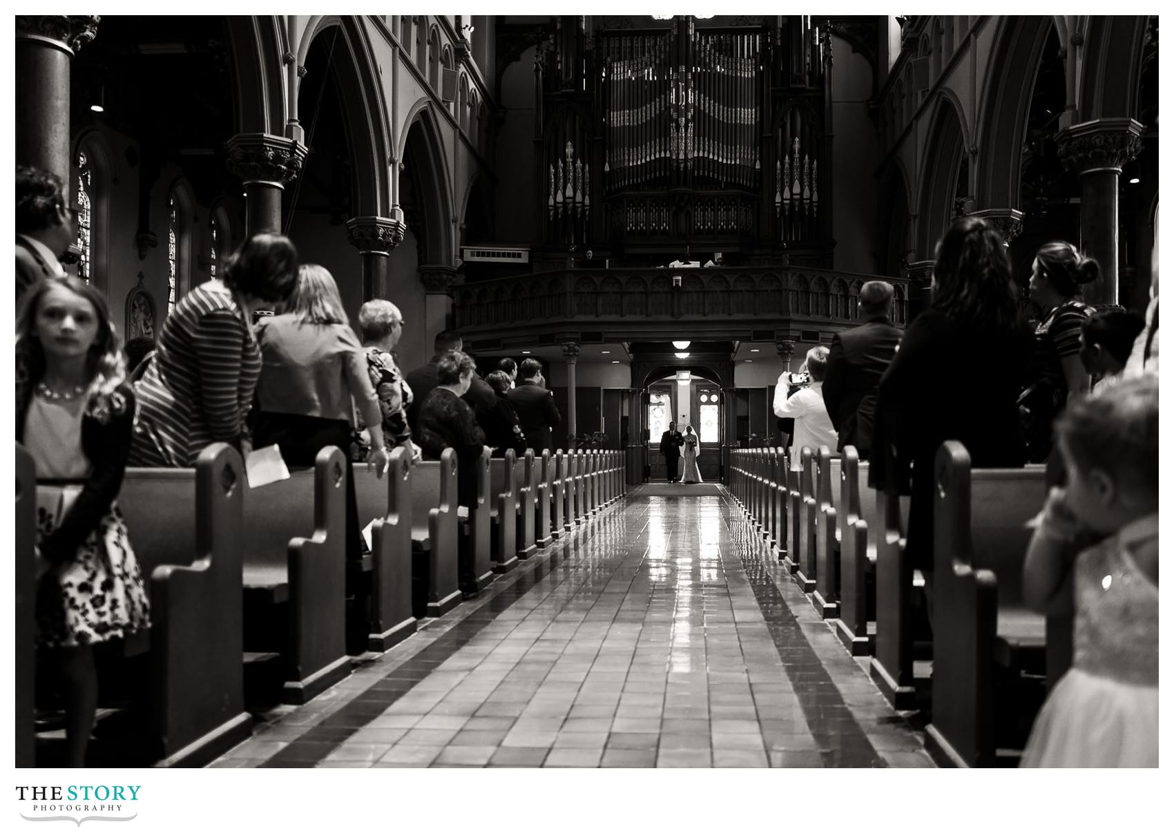 bride and her father about to walk down the aisle at the cathedral of the immaculate conception