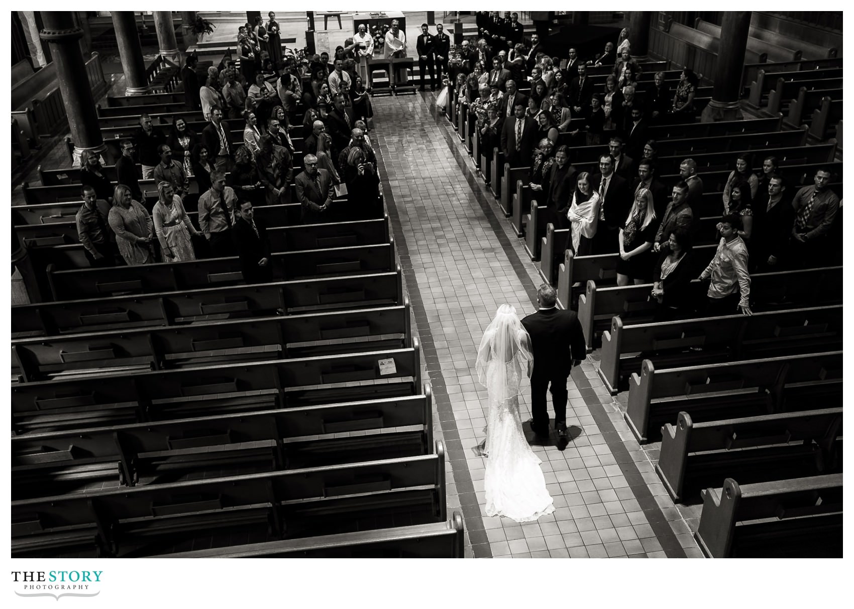 bride walkting down aisle at cathedral wedding in syracuse