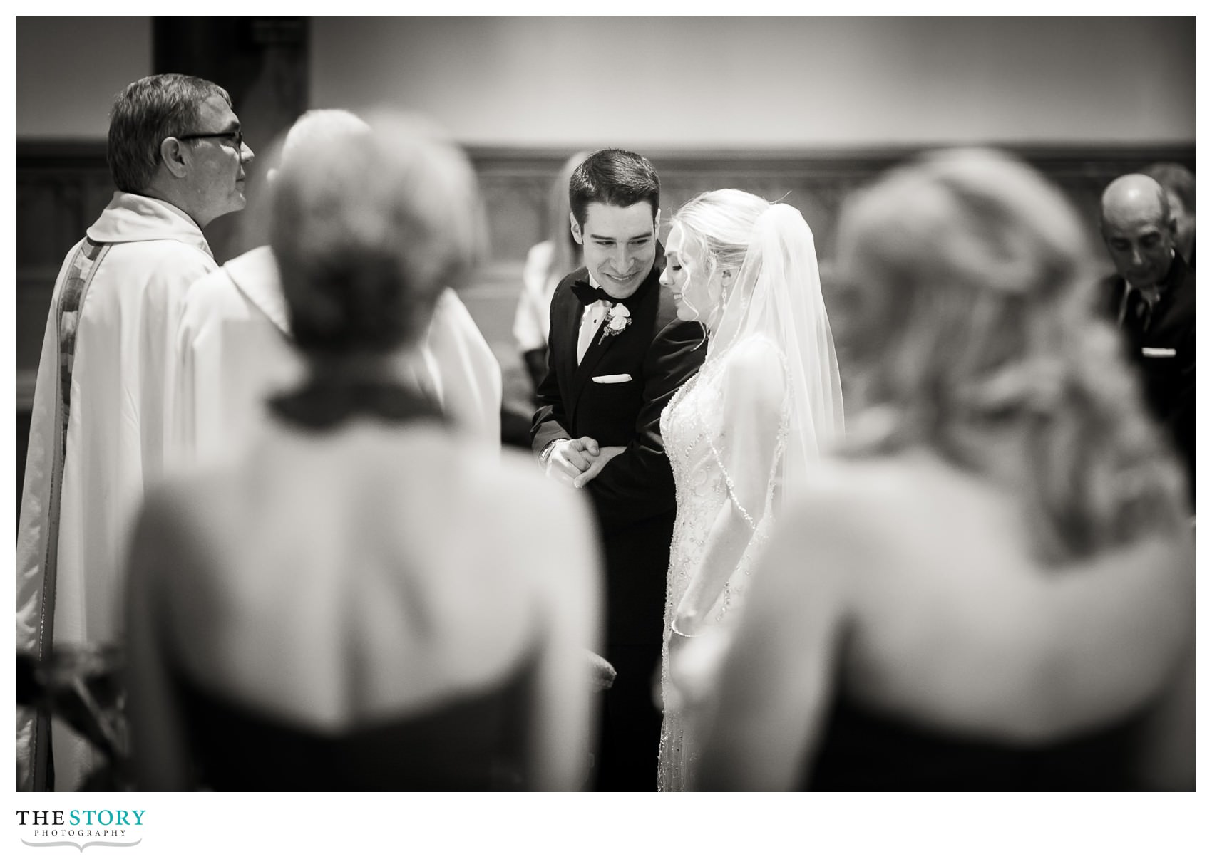 bride and groom share a little moment during wedding ceremony at Cathedral of the Immaculate Conception