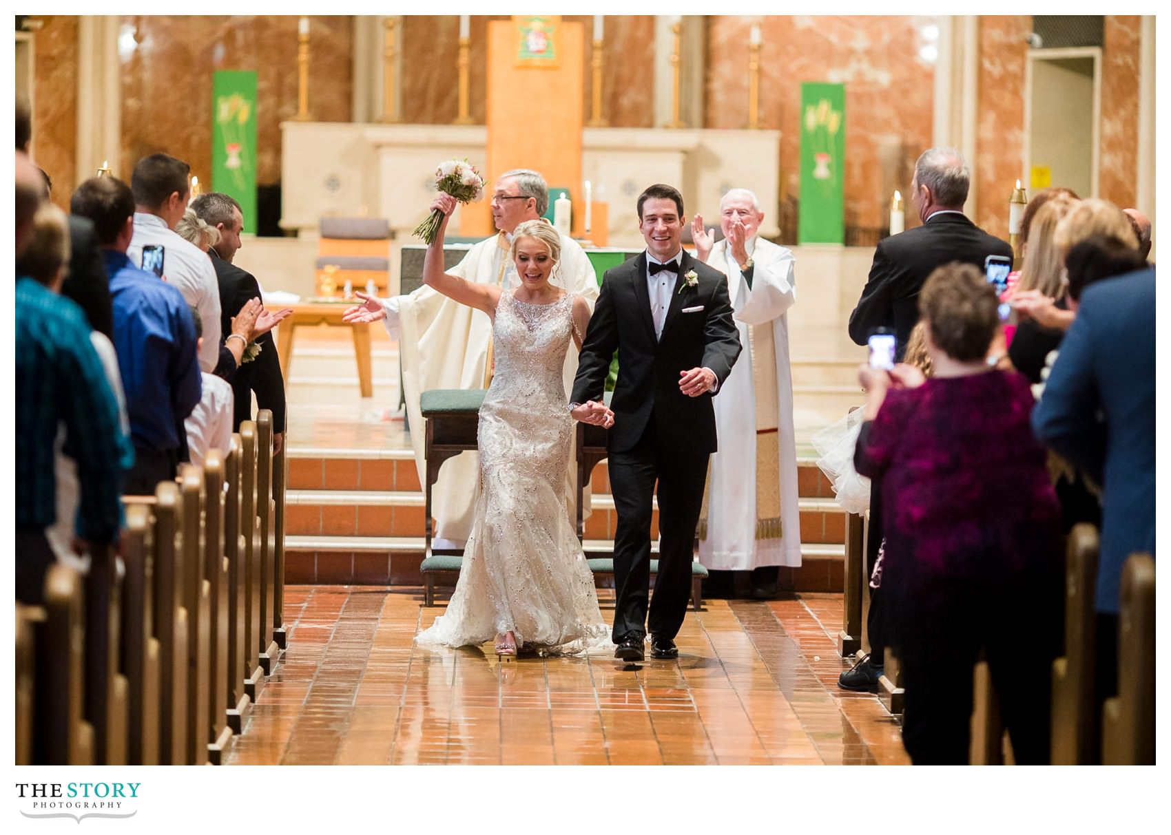 celebrating the new marriage as they walk down the aisle as husband and wife