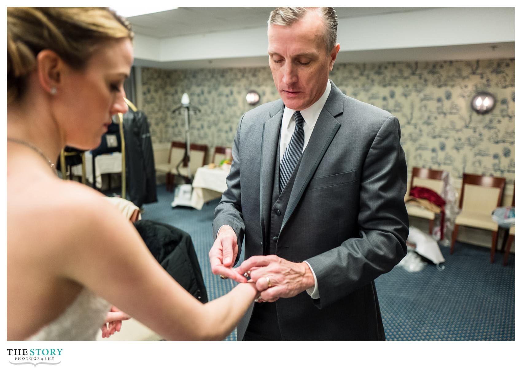 father of bride helps with putting on her bracelet before the Cooperstown wedding