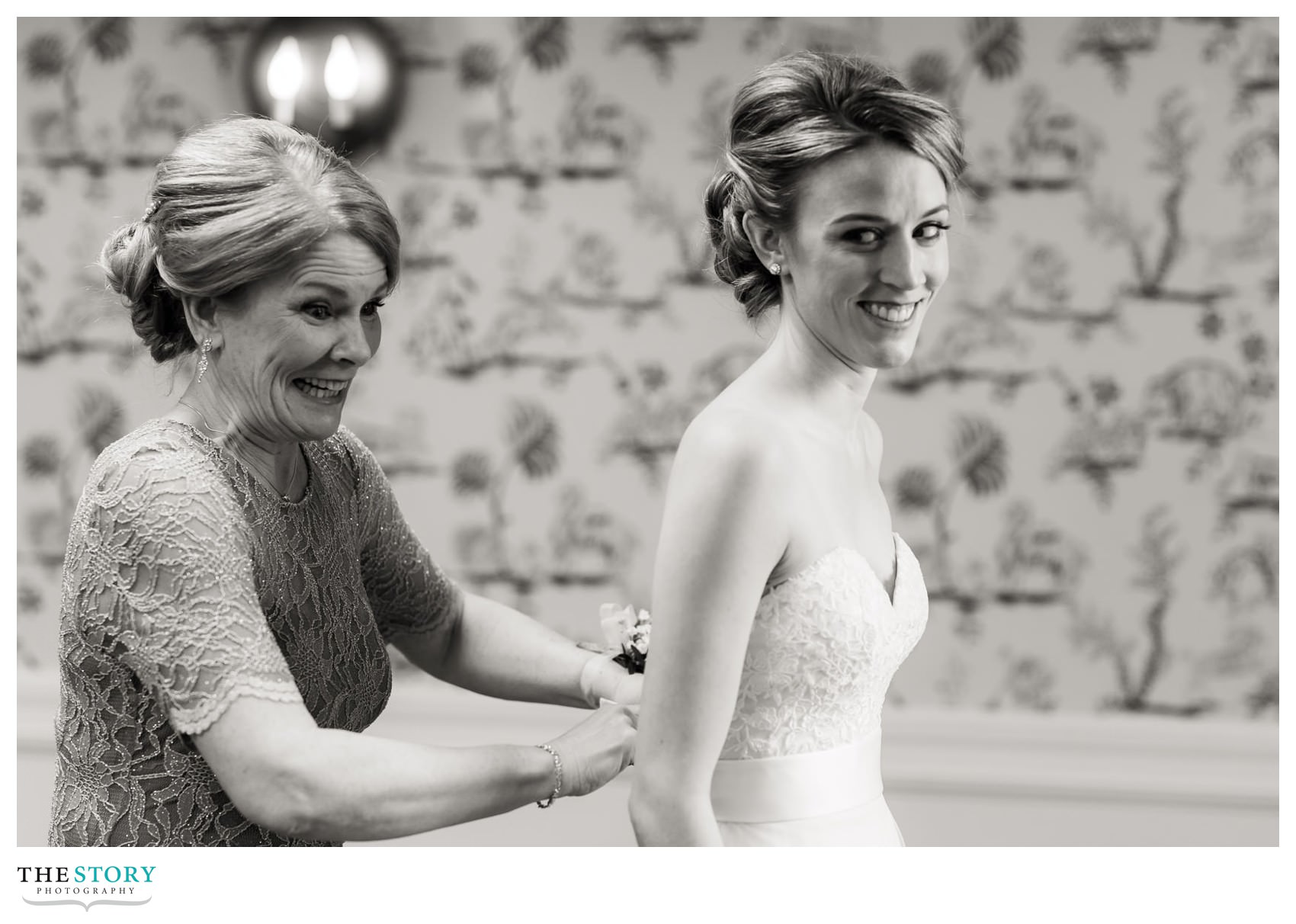 mother of bride helps with the wedding dress at The Otesaga