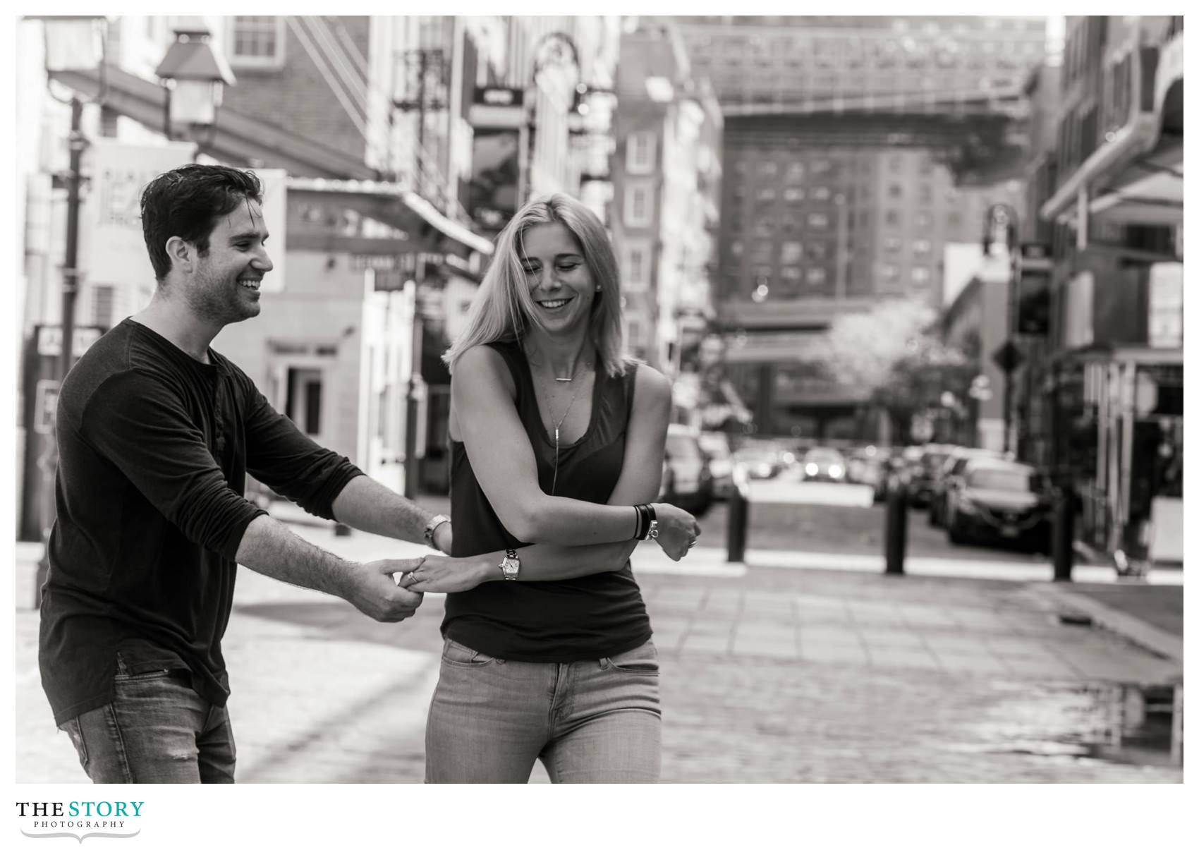 black and white photo of couple dancing on Front Street