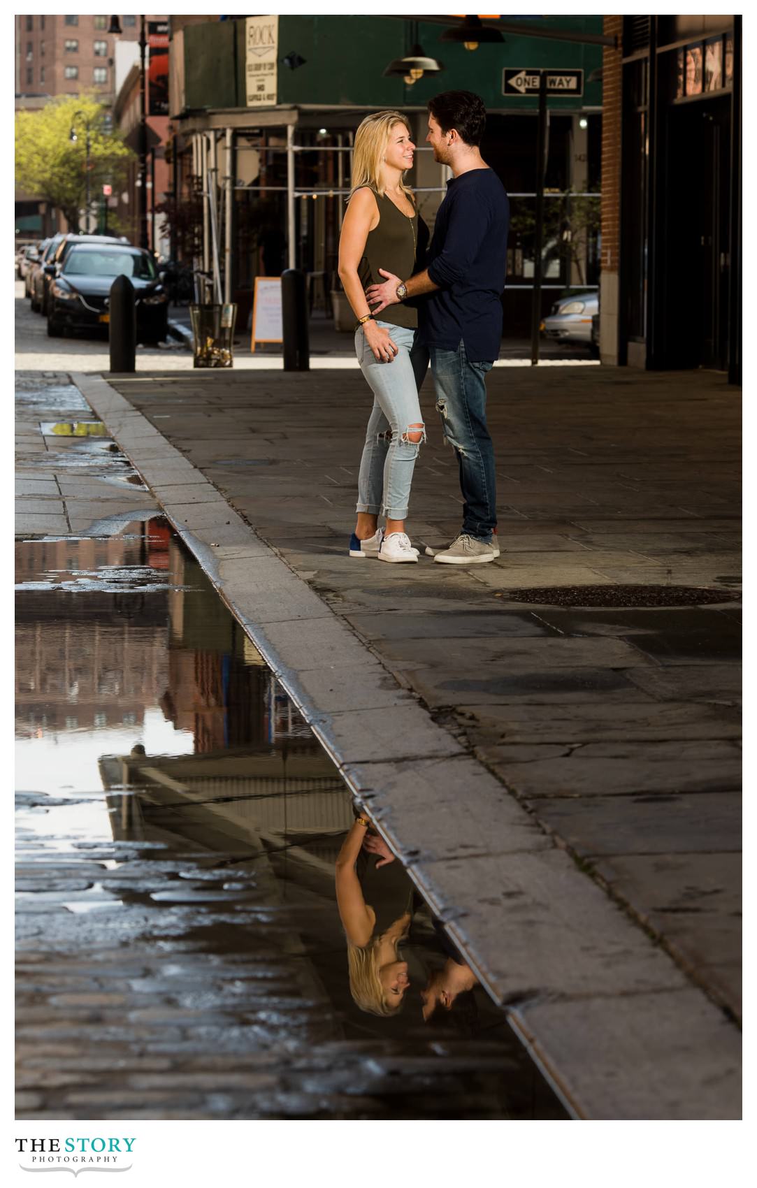 reflection photo of engaged couple on Front Street