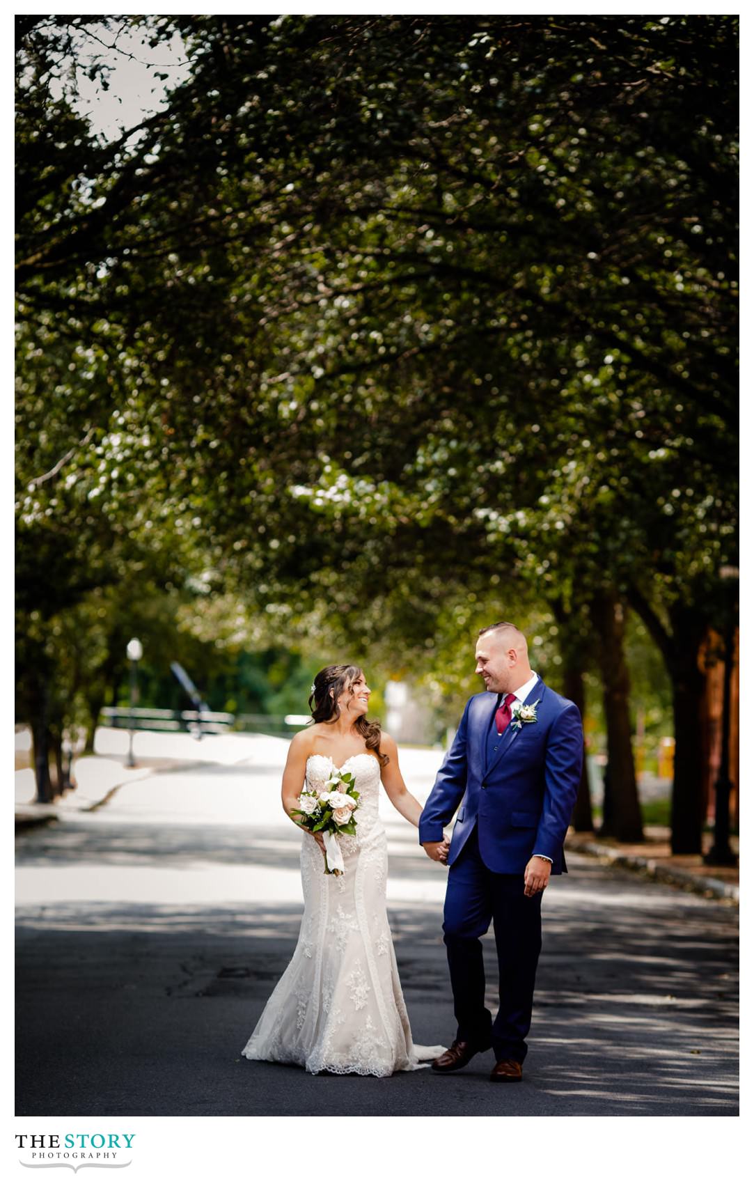 Bride and Groom walking down street for Wedding portrait at Franklin Square in Syracuse