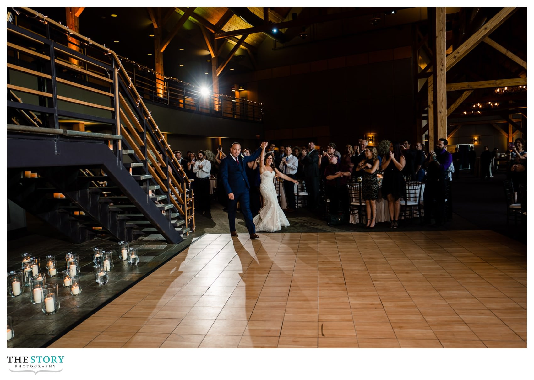 bride and groom enter the wedding reception at The Lodge at Welch Allyn for their first dance