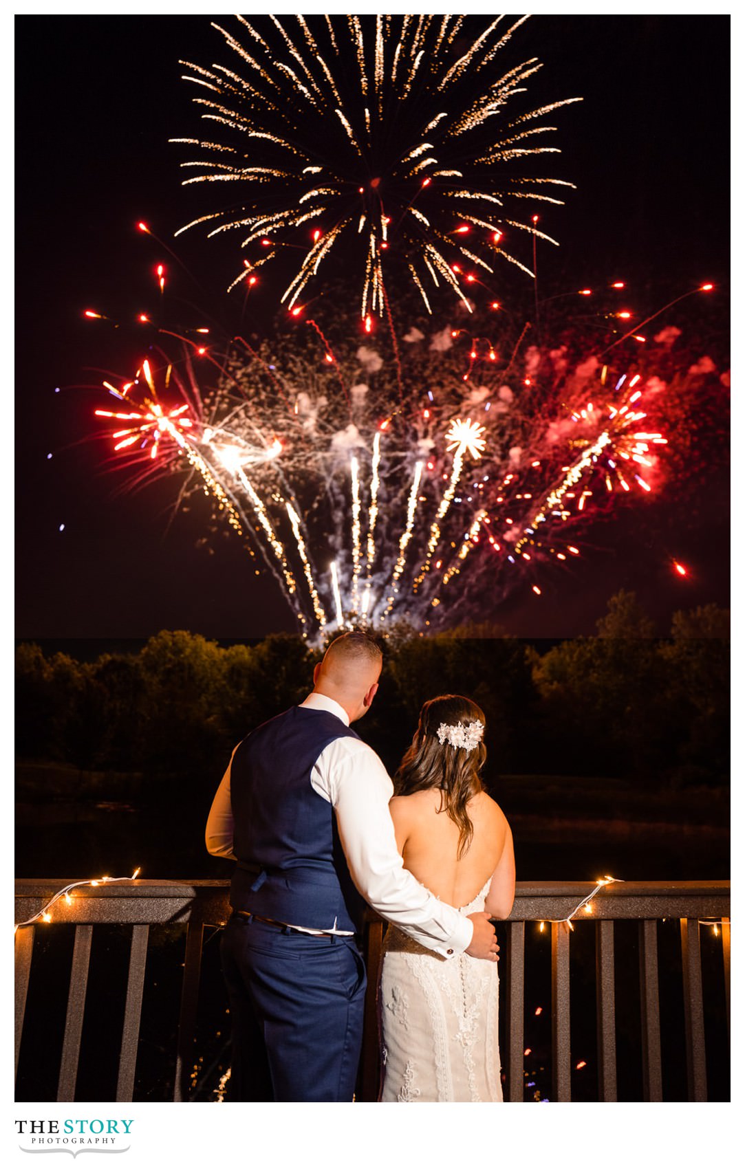 bride and groom enjoy fireworks show during their wedding reception in Skaneateles