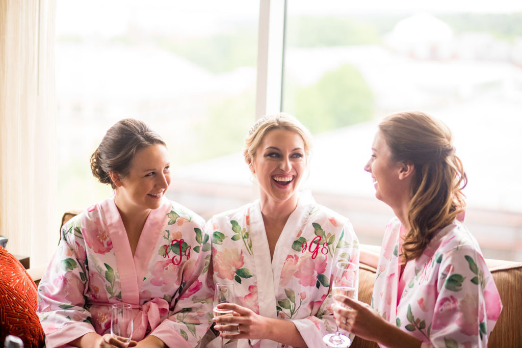 bride enjoying a fun moment with bridesmaids before wedding