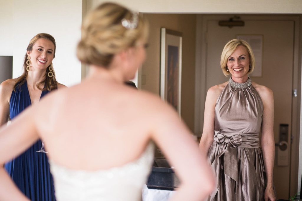 mother and bridesmaid enjoy seeing the bride for the first time