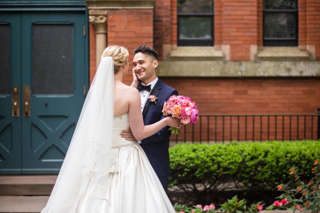 bride and groom enjoying their first look outside Sage Chapel at Cornell