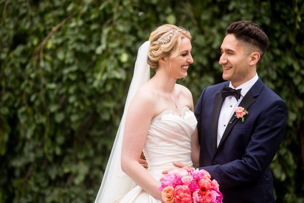 candid moment with bride and groom on Cornell University campus