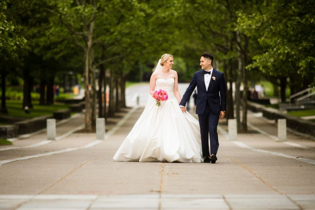bride and groom walking down Ho Plaza on Cornell University campus