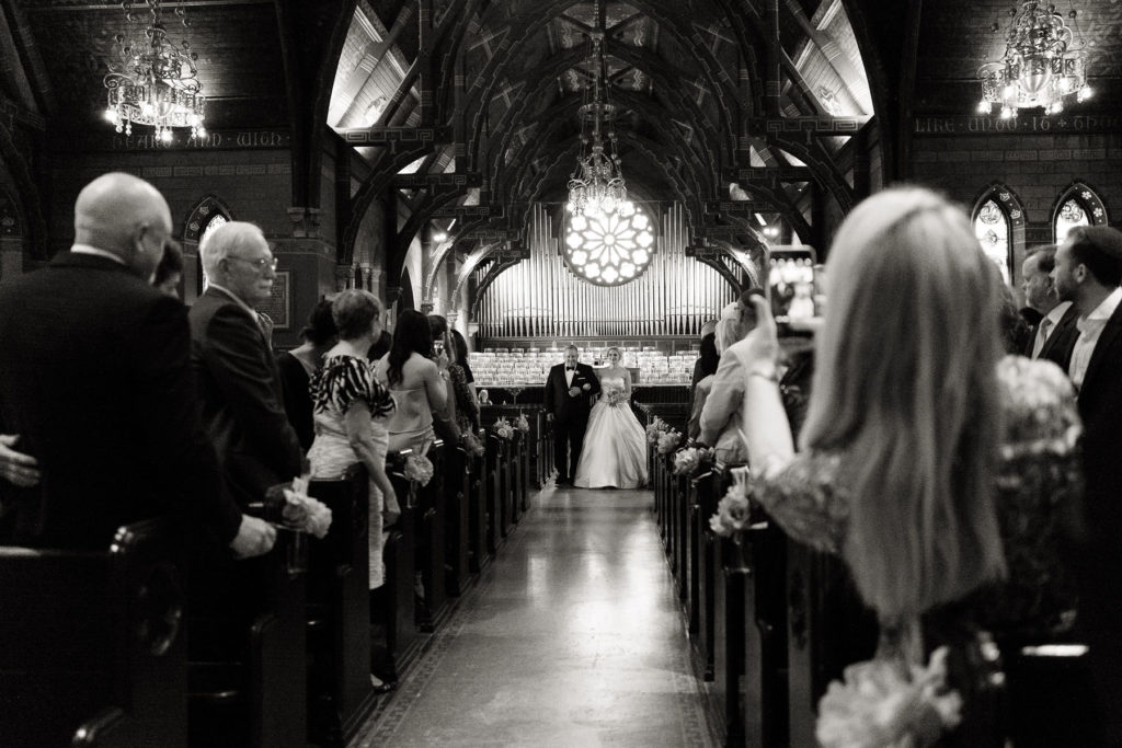 bride walks the Sage Chapel aisle during wedding ceremony