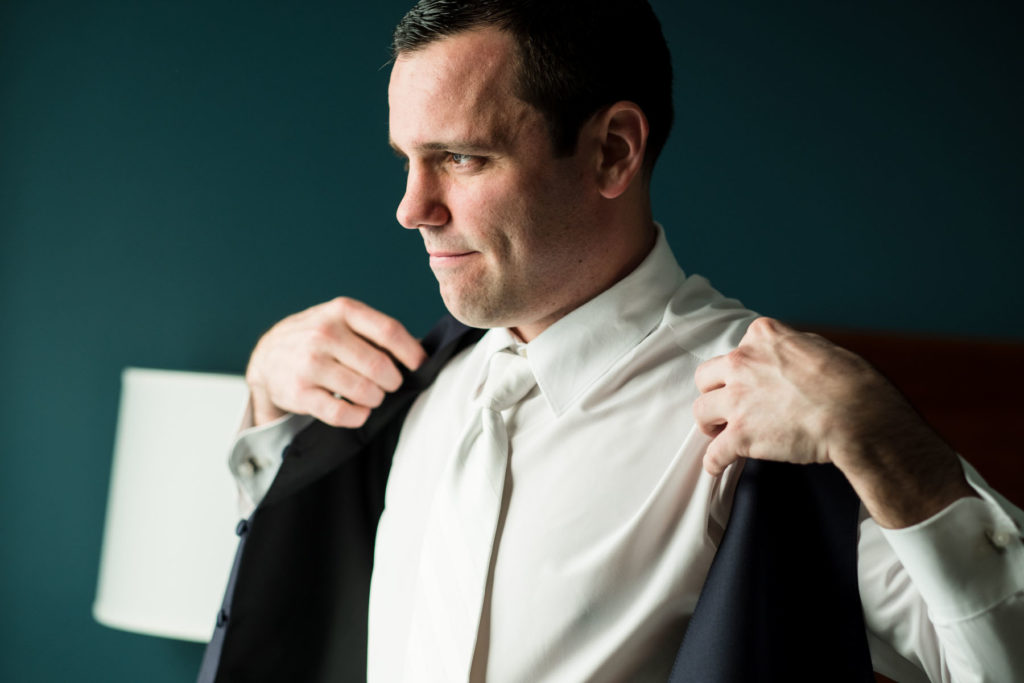 groom getting dressed before wedding day at Ventosa Vineyard