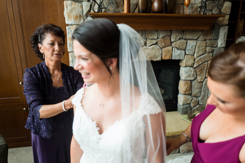 Mother of bride helping with adjusting dress