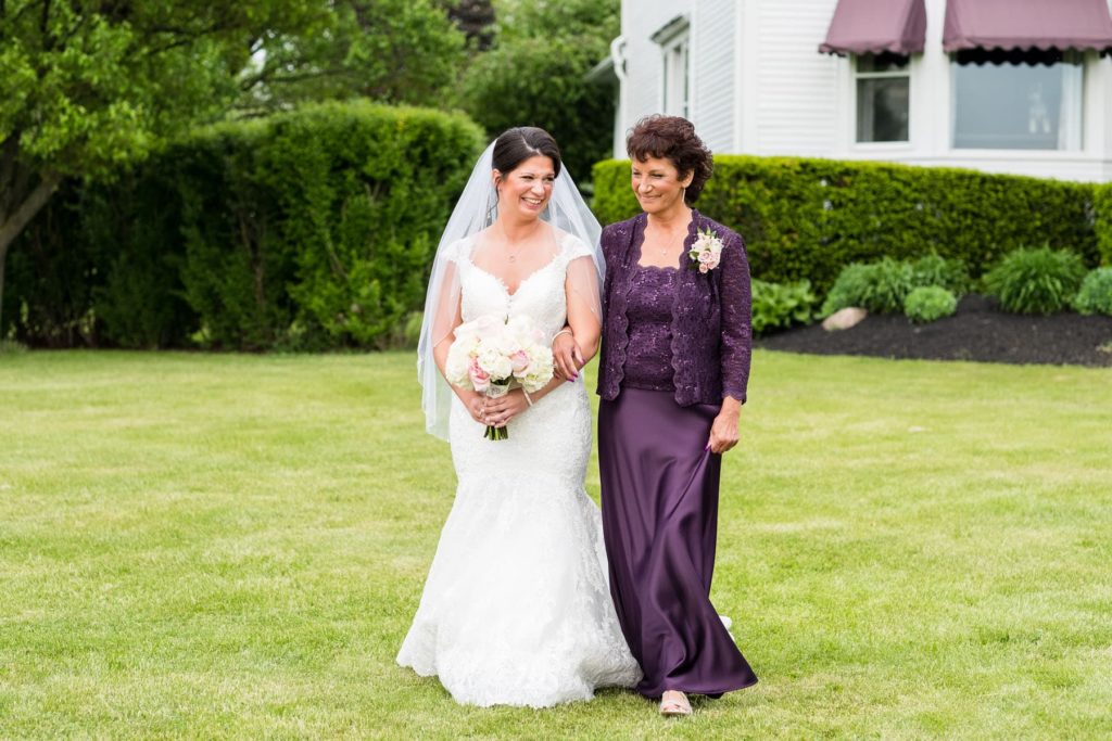 mother and bride walking in to outdoor wedding ceremony at Ventosa Vineyard