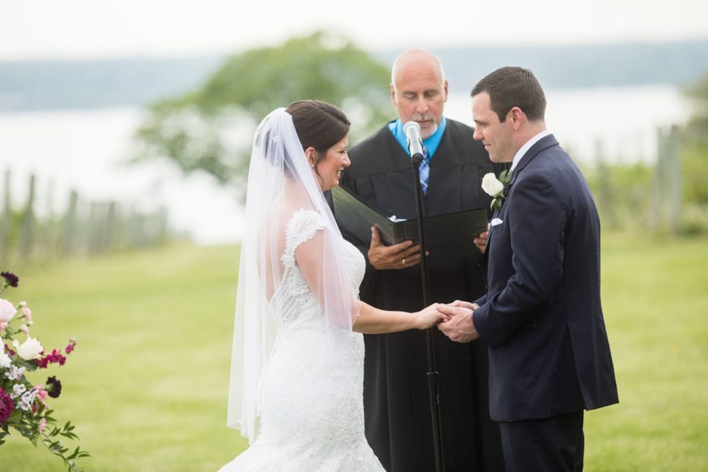 bride and groom holding hands at Finger Lakes outdoor wedding ceremony