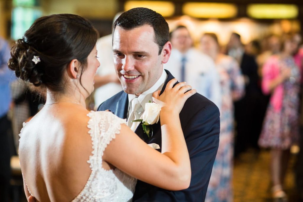 bride and groom enjoying the first dance . at their wedding reception